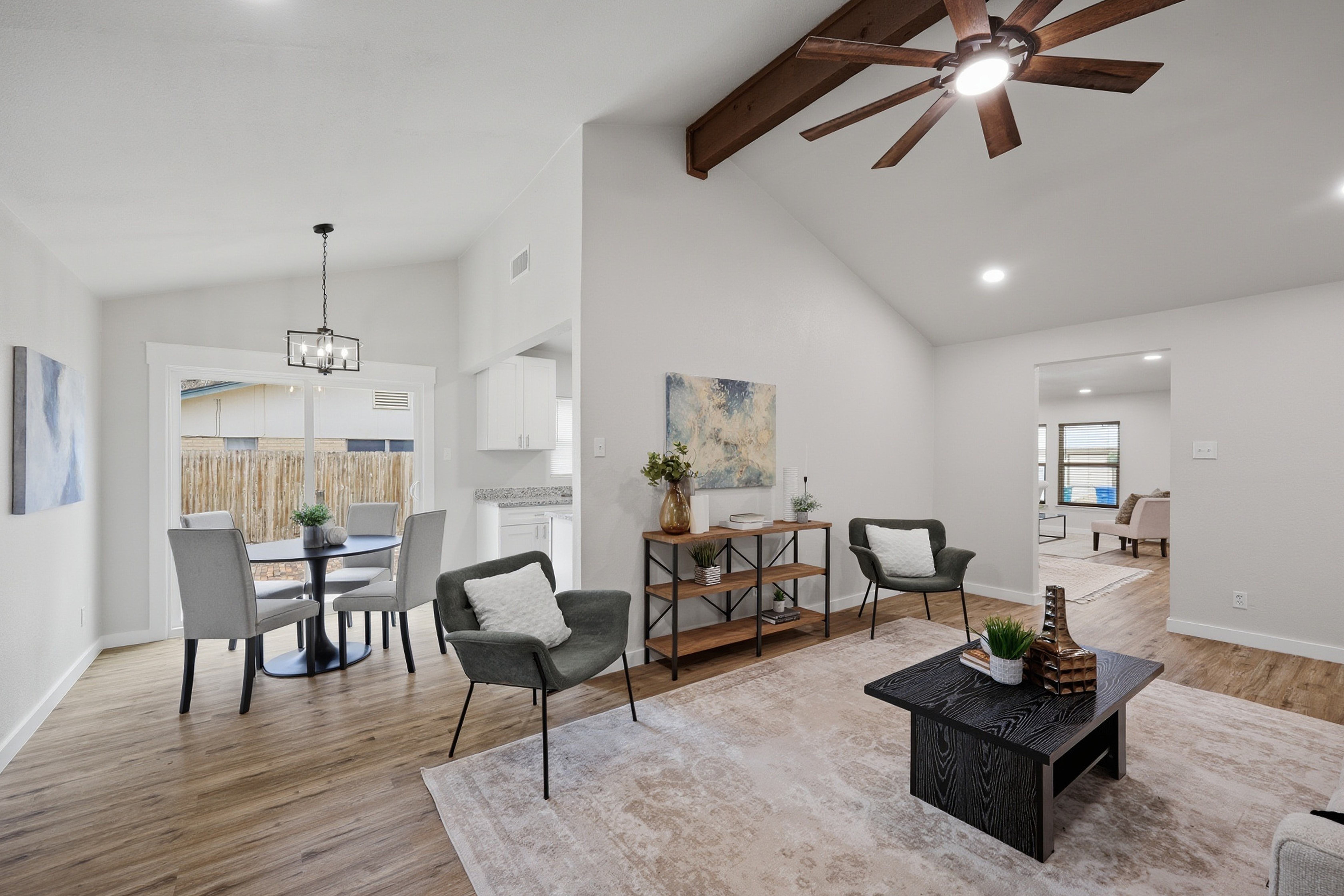 Open-concept family room and dining area with vaulted ceilings and natural light